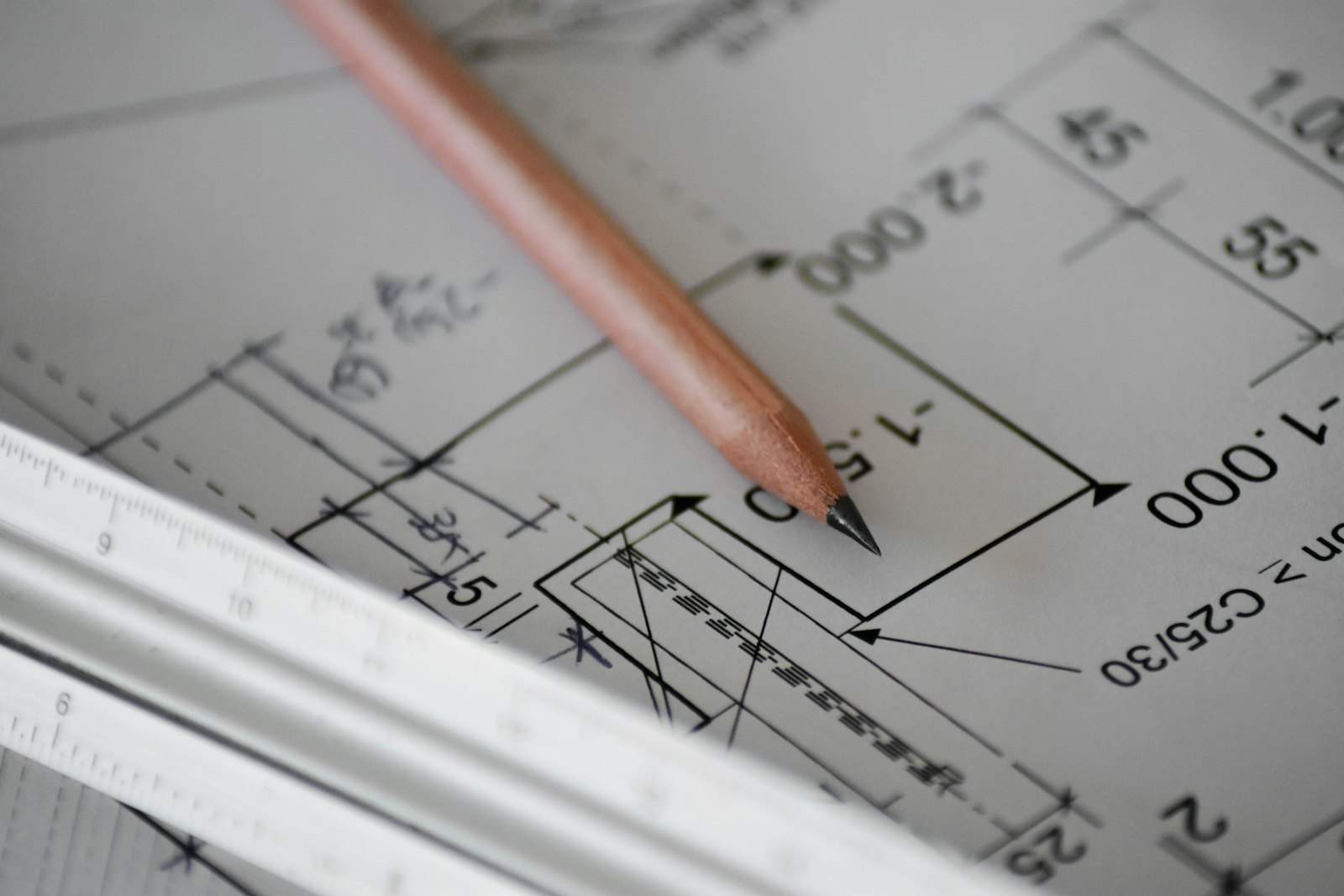 Architect's drawings for a building conversion with a pencil and ruler